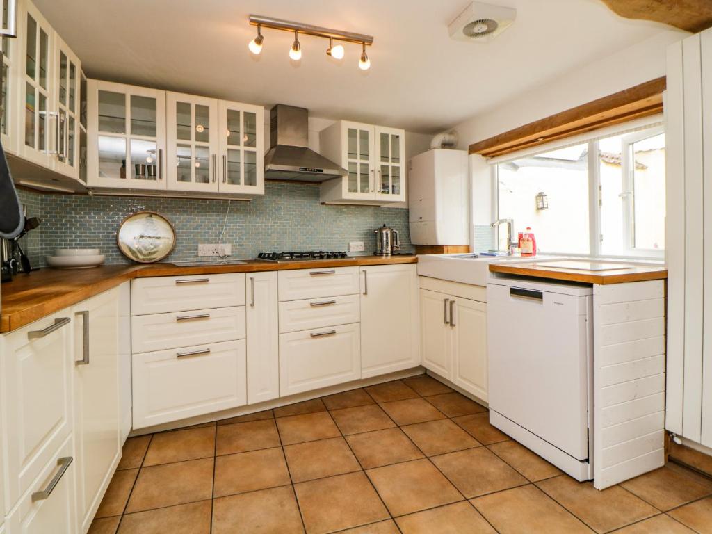 Modern kitchen with direct patio access at Seaside Cottage